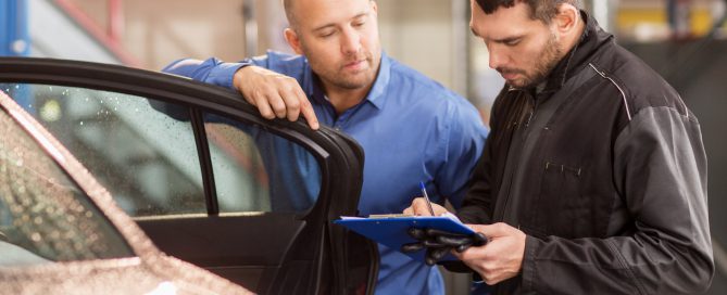 auto mechanic and customer at car shop