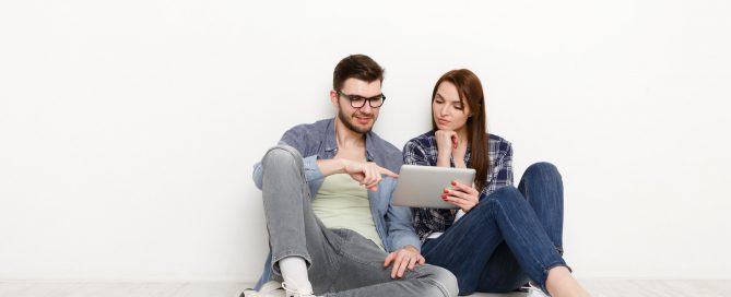 Couple ordering purchase with digital tablet