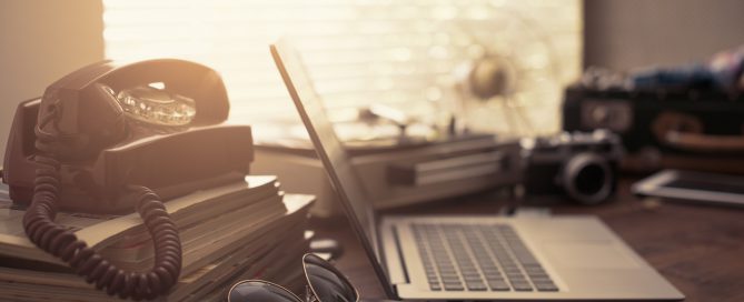 Vintage desktop with laptop and suitcase