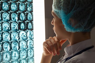 Woman doctor examining x-ray
