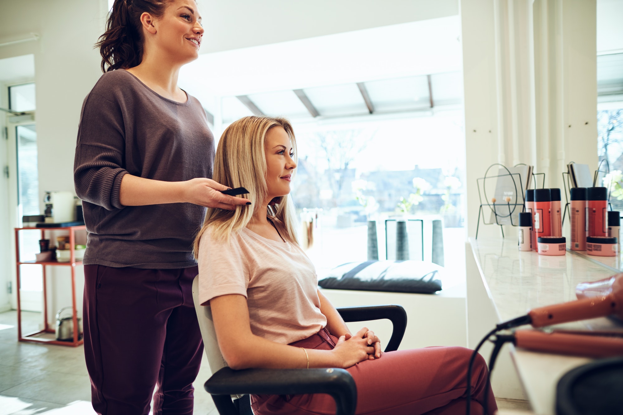 Smiling woman talking with her hairstylist in a salon
